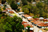 Timorese Village Photo: A small village in East Timor rendered in photoshop to recreate a tilt-shift lens effect.