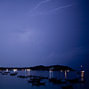 Beach Light Show Photo: Pattaya beach & resting songthaew (boats) partially illuminated by a bolt of lightning.  Of course this isn't the infamous Pattaya, a few hours from Bangkok.  It's a Pattaya beach on the small island paradise in the south of Thailand near Malayasia.