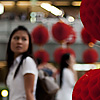 Paper Balls Photo: A Thai student passes an ornamental red lantern that decorates the walkway at the Paragon Mall.