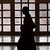 Beauty's Bowels Photo: A mother and child walk past a large lattice window inside the Taj Mahal mausoleum.