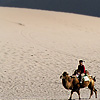 Camel Jockeys Photo: Chinese tourists take double-humped camels out for a spin around the Singing Sand Dunes of Dunhuang. 