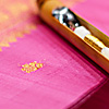 Gold Code Photo: A shuttle rests on an unfinished silk saree.