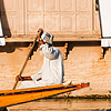 Water Dwellings Photo: A Kashmiri man rows past the shaded windows of a houseboat on Dal Lake.