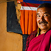 Brawn & Wall Photo: A Buddhist monk poses in front of a colorful wall.