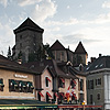 Riverfront Gourmands Photo: Tourists dine on the waterfront as the Annecy castle towers behind.