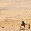 Desert Dynasties (Panorama Inside) Photo: Tourists wander the desert around the pyramids of Giza.