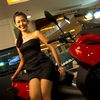 Motorcycle Models (Red) Photo: A classy Thai model shows off the latest in Piaggio motorcycles at Central World Mall in Bangkok.