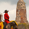photo: Pachyderm Package-Tour - Tourists leisurely see the sites on elephant back in the old capitol of Thailand, Ayutthaya.