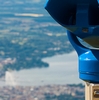 Lakeside Canton Photo: A coin-operated set of binoculars overlooks the city of Geneva from the Saleve viewpoint in France.