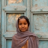 Door Girl Photo: A cute Indian girl stands in front of a worn front door in Bijapur, India (ARCHIVED PHOTO on the weekends - originally photographed 2009/02/22).
