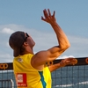 Big Ups Photo: A men's beach volleyball player jumps sky-high for a spike during a tournament sponsored by Coop in Geneva.