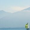 photo: Solo Sailing - A lone sailboat navigates Annecy Lake on a foggy morning.